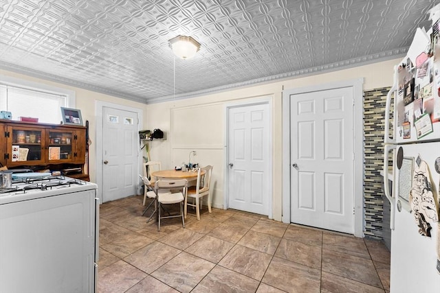 interior space featuring white range with gas cooktop and light tile patterned floors