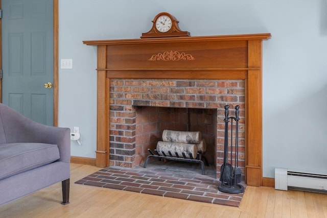 8 Macleod Ln, Acton, MA 01720 - detailed view of a baseboard radiator, wood finished floors, baseboards, and a fireplace