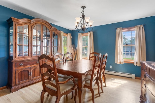 8 Macleod Ln, Acton, MA 01720 - dining room featuring a baseboard radiator, a chandelier, light wood finished floors, and plenty of natural light