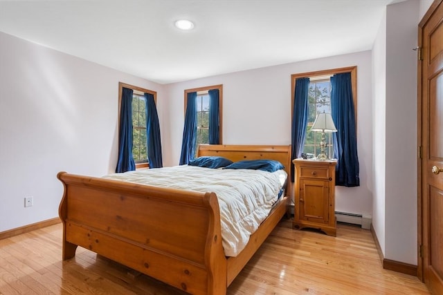 8 Macleod Ln, Acton, MA 01720 - bedroom featuring a baseboard radiator, baseboards, light wood-type flooring, and recessed lighting