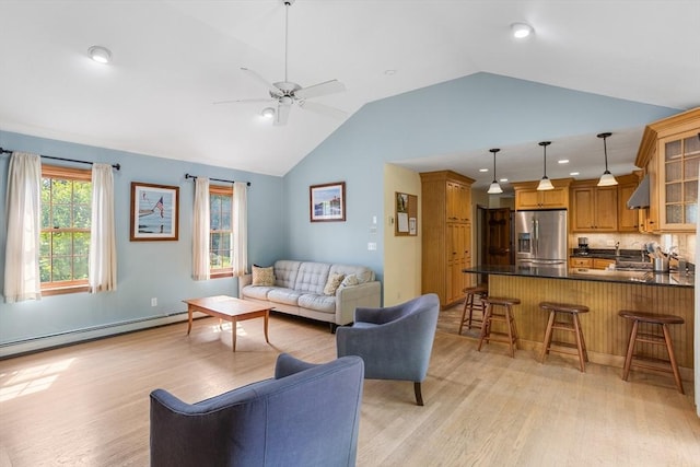 8 Macleod Ln, Acton, MA 01720 - living area with vaulted ceiling, light wood finished floors, ceiling fan, a baseboard radiator, and recessed lighting