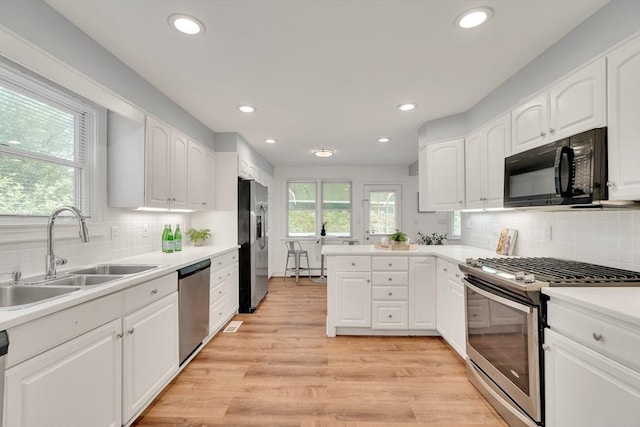 100 Summit, Brookline, MA 02446 - kitchen with appliances with stainless steel finishes, a sink, white cabinetry, decorative backsplash, and recessed lighting