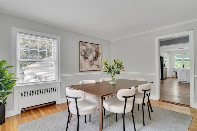 100 Summit, Brookline, MA 02446 - dining room with radiator heating unit, light wood-style floors, ornamental molding, and baseboards