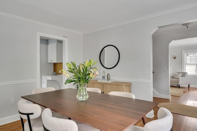 100 Summit, Brookline, MA 02446 - dining space featuring arched walkways, wood finished floors, baseboards, and ornamental molding