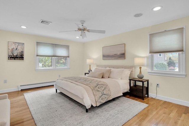 100 Summit, Brookline, MA 02446 - bedroom featuring baseboard heating, multiple windows, light wood-style floors, baseboards, and recessed lighting