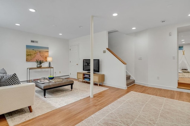 100 Summit, Brookline, MA 02446 - living area featuring wood finished floors, stairs, recessed lighting, baseboards, and a baseboard heating unit