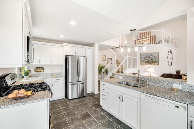 kitchen featuring white cabinets, pendant lighting, stainless steel appliances, and sink