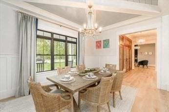 dining space featuring hardwood / wood-style floors and a notable chandelier