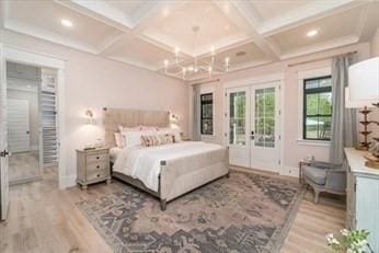 bedroom featuring access to exterior, french doors, coffered ceiling, beam ceiling, and hardwood / wood-style flooring