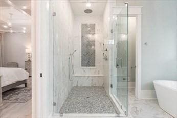 bathroom featuring shower with separate bathtub