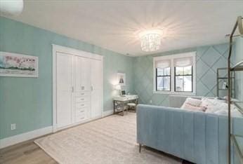 living room with a chandelier and hardwood / wood-style flooring