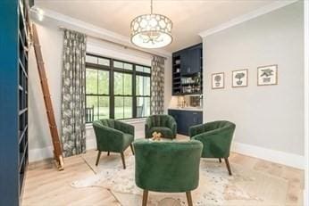 sitting room featuring crown molding and wood-type flooring