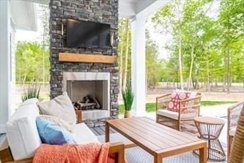 view of patio / terrace featuring a stone fireplace