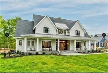 back of house with a lawn and a porch