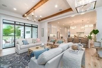 living room with a chandelier, hardwood / wood-style floors, and beamed ceiling