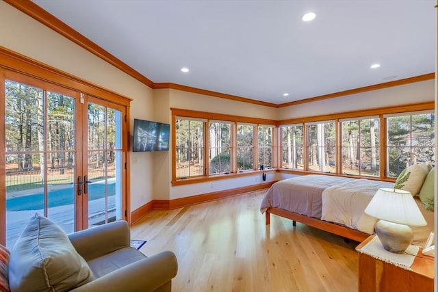 bedroom featuring crown molding, access to outside, french doors, and light wood-type flooring