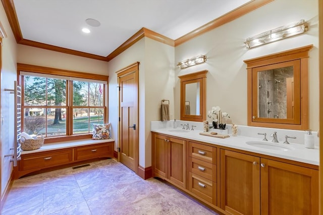 bathroom featuring crown molding and vanity