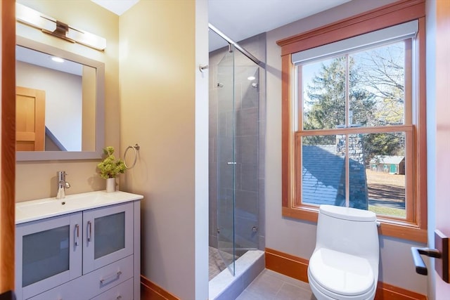 bathroom featuring tile patterned floors, vanity, toilet, and a shower with shower door