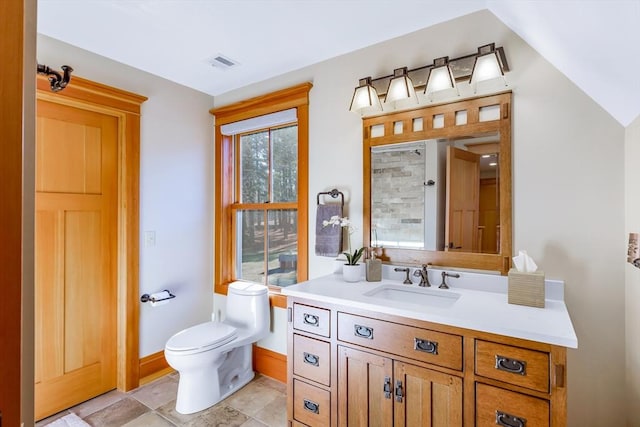 bathroom featuring vanity, vaulted ceiling, and toilet