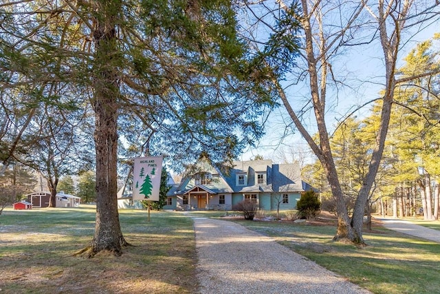 cape cod home with a front yard