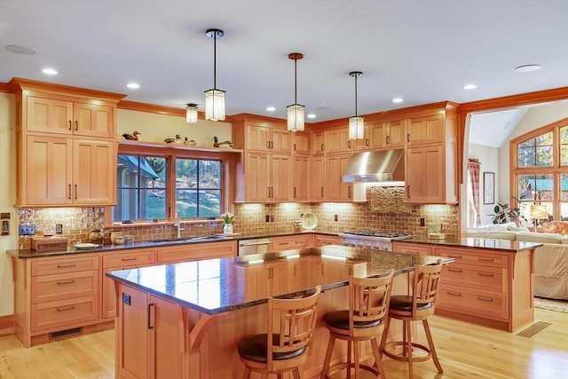 kitchen with a kitchen bar, sink, and a kitchen island