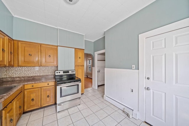633 E Sixth St, Boston, MA 02127 - kitchen with stainless steel range with electric stovetop, ornamental molding, a baseboard heating unit, arched walkways, and light tile patterned floors