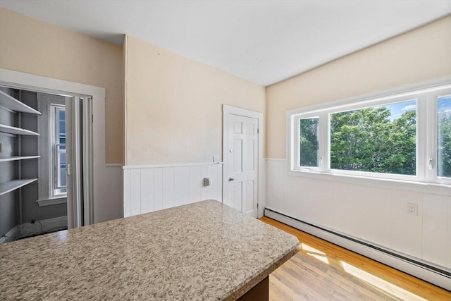 633 E Sixth St, Boston, MA 02127 - kitchen with a baseboard heating unit, light wood finished floors, a wainscoted wall, and light countertops