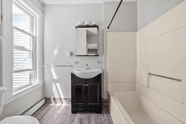 633 E Sixth St, Boston, MA 02127 - full bath featuring a baseboard heating unit, vanity, tub / shower combination, and plenty of natural light
