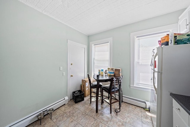 633 E Sixth St, Boston, MA 02127 - dining area featuring a baseboard heating unit and light tile patterned flooring