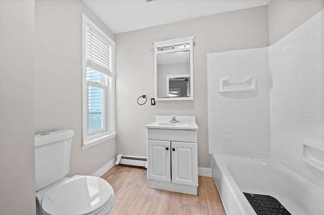 633 E Sixth St, Boston, MA 02127 - bathroom with a baseboard radiator, wood finished floors, toilet, vanity, and bathing tub / shower combination