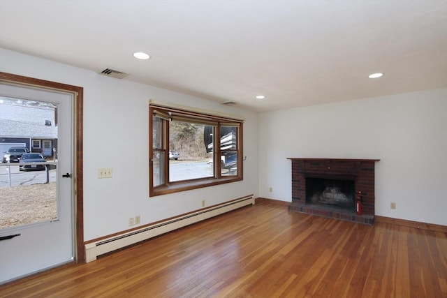 unfurnished living room with recessed lighting, visible vents, light wood-style flooring, and a baseboard radiator