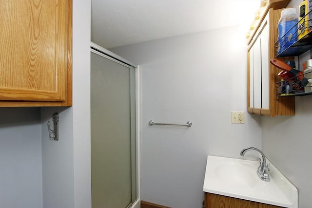 full bathroom featuring a stall shower and vanity