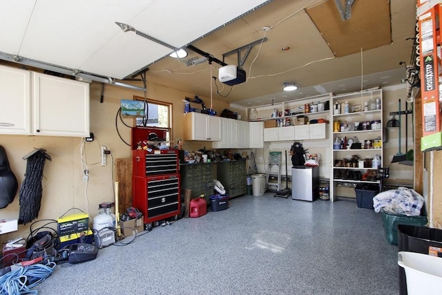 garage with a workshop area and a garage door opener