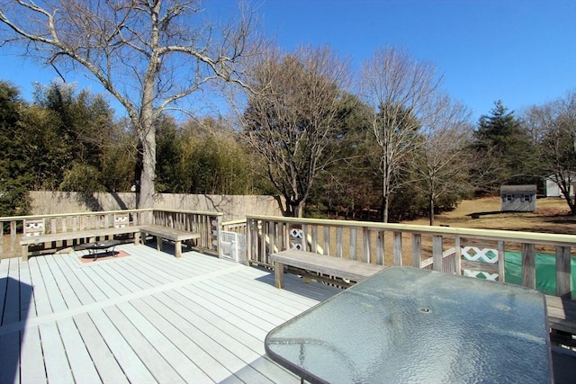 wooden terrace featuring outdoor dining space, fence private yard, and area for grilling