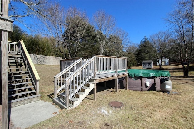 wooden deck with an outdoor structure and stairway