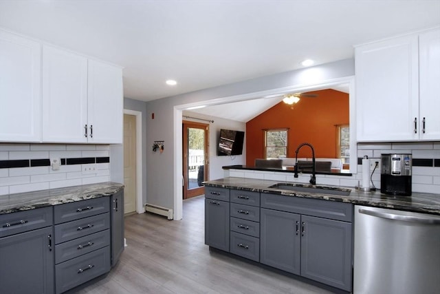 kitchen featuring dishwasher, a baseboard radiator, and gray cabinetry