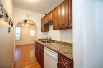 16-18 Orchard St, Grafton, MA 01560 - kitchen featuring dishwasher, light wood-style flooring, brown cabinets, stone countertops, and a ceiling fan