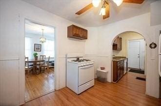 16-18 Orchard St, Grafton, MA 01560 - kitchen featuring white gas range oven, a ceiling fan, wood finished floors, and arched walkways