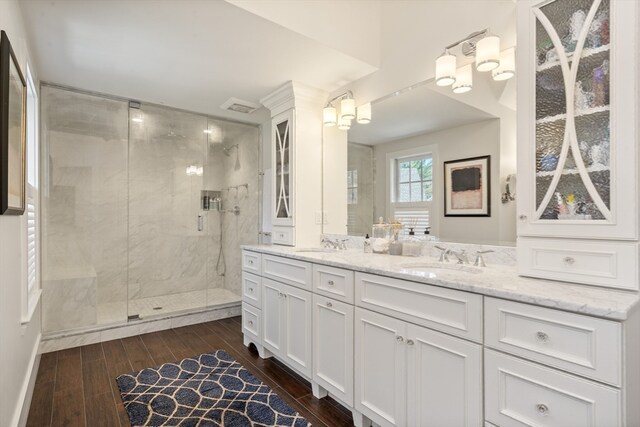 bathroom featuring vanity, an enclosed shower, and hardwood / wood-style floors