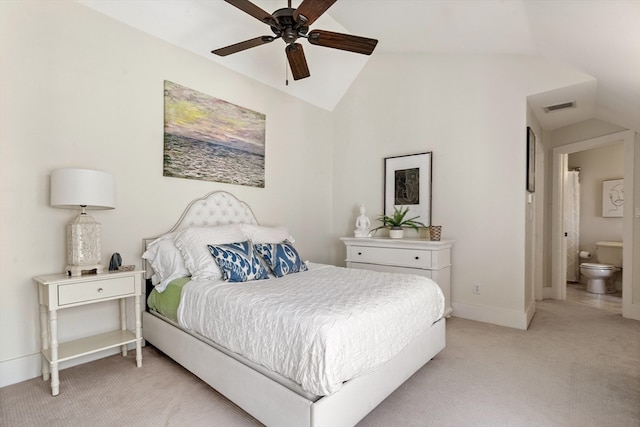 carpeted bedroom with connected bathroom, vaulted ceiling, and ceiling fan