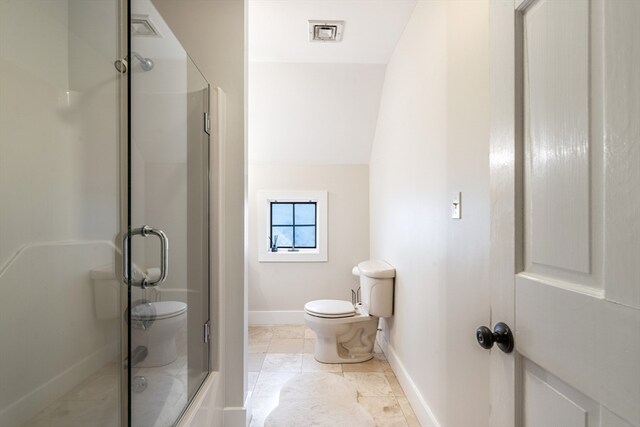 bathroom with tile patterned floors, vaulted ceiling, a shower with shower door, and toilet