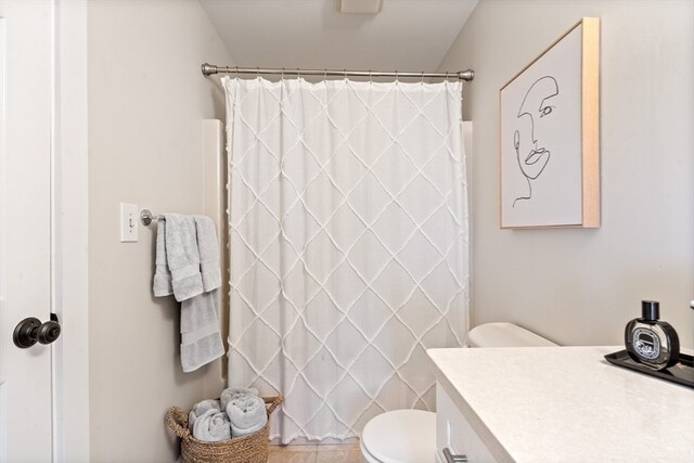 bathroom with vanity, a shower with shower curtain, toilet, and tile patterned floors