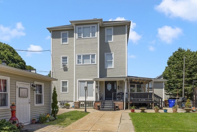 506 Snell St, Fall River, MA 02721 - view of front of house with a front yard, a wooden deck, and a patio