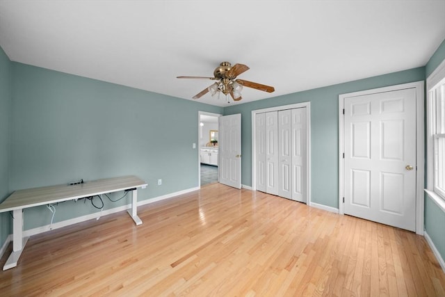 unfurnished bedroom featuring ceiling fan, wood finished floors, and baseboards