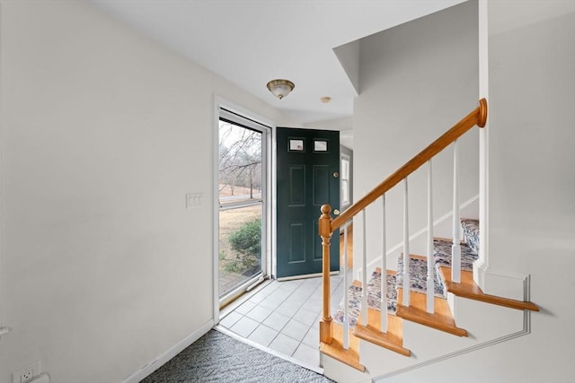 entryway with stairway and baseboards