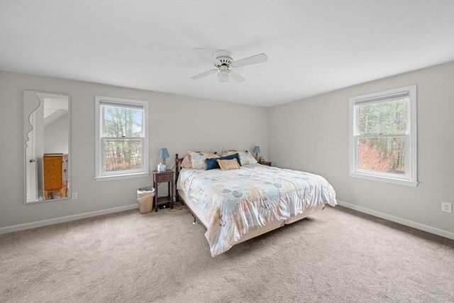 carpeted bedroom featuring ceiling fan and baseboards