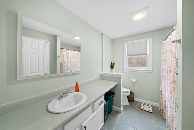 full bath with toilet, tile patterned floors, baseboards, and vanity