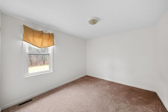 carpeted empty room with baseboards and visible vents