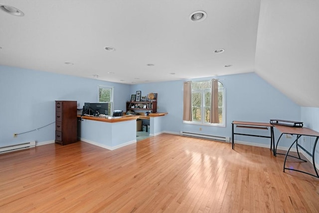 interior space with light wood-type flooring, baseboards, vaulted ceiling, and baseboard heating