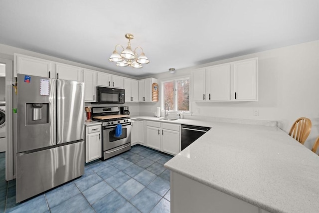 kitchen featuring white cabinets, appliances with stainless steel finishes, a peninsula, a chandelier, and a sink